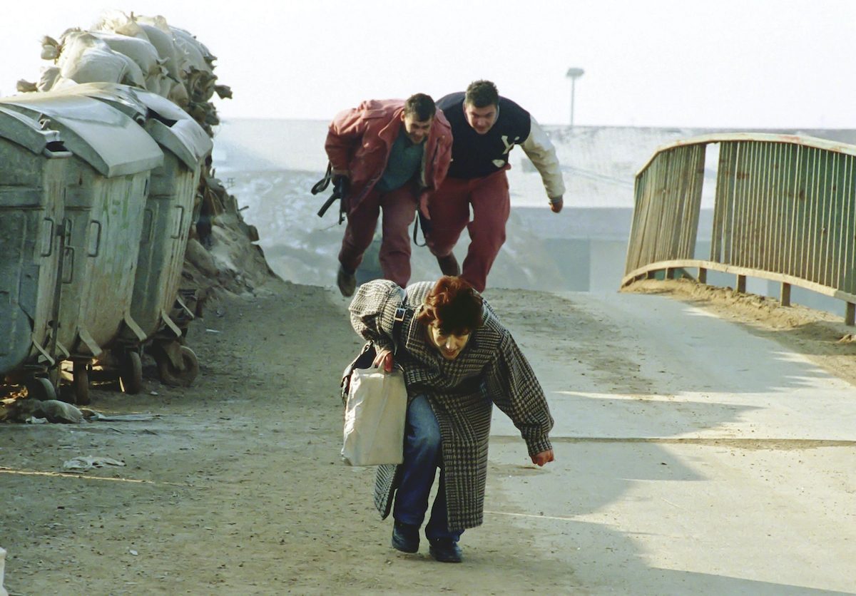 Resident at the cut-off suburb of Dobringe have crouch to dodge snipers when crossing a dangerous bridge where more than 60 people have become casualties. The residents are under siege from Serb snipers and mortars and have to bury their dead close to their homes. Snipers and mortar bombardments claim lives every day and even the makeshift cemeteries are not safe as mourners are attacked as they bury their loved ones. Sarajevo 1993